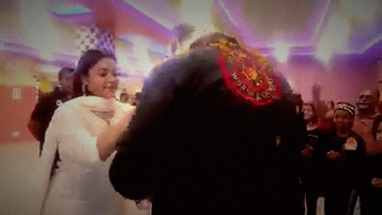 A student places a marigold garland around Richard's neck on arrival in Kolkata